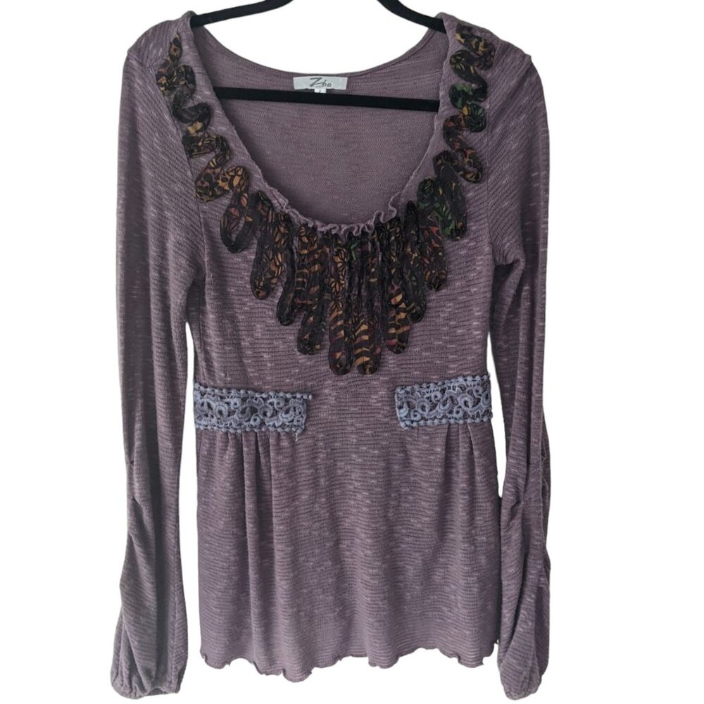 Purple long sleeve top with fabric embellishments